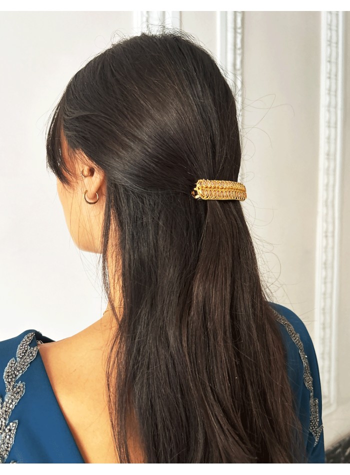 Golden barrette with pink crystals in the shape...