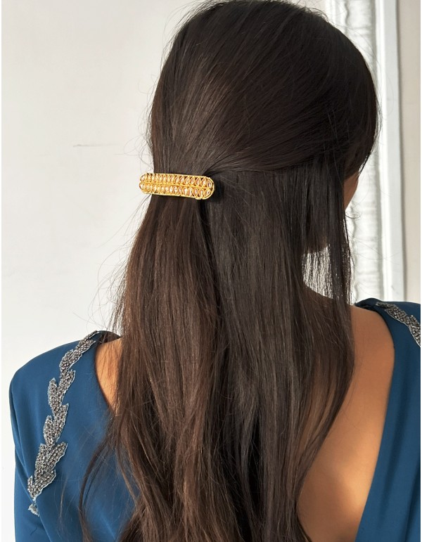 Golden barrette with pink crystals in the shape of leaves