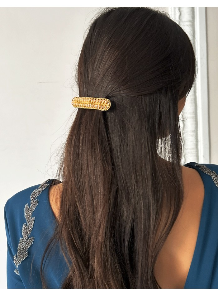 Golden barrette with pink crystals in the shape of leaves