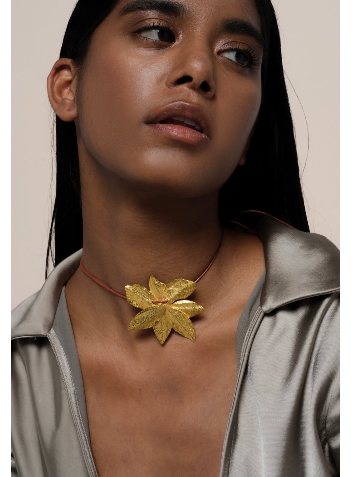 Golden necklace in the shape of lotus flower