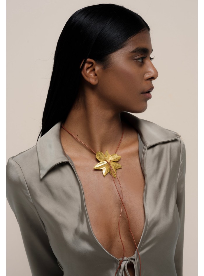 Golden necklace in the shape of lotus flower