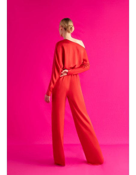 Asymmetric red jumpsuit with bat sleeves and belt