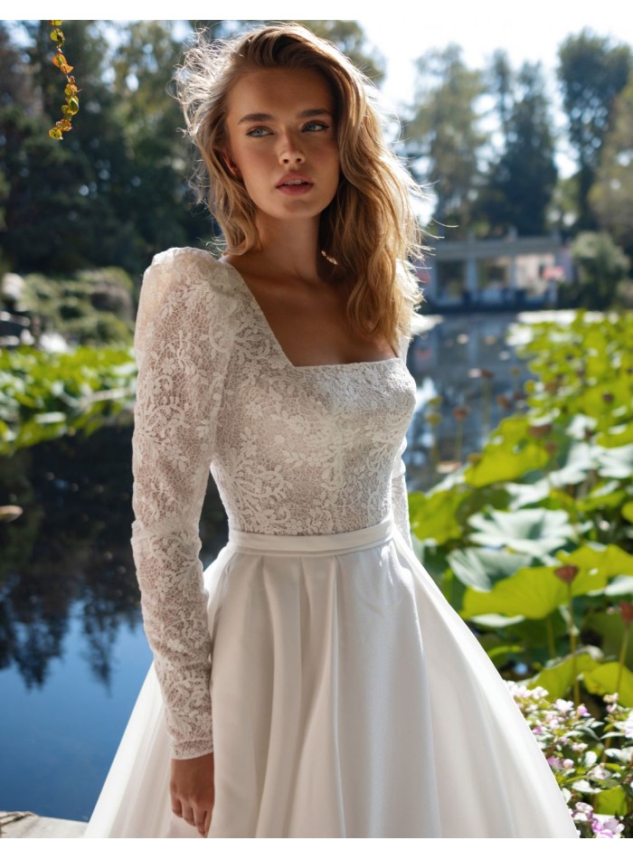 Ivory wedding dress with lace bodice and long sleeves