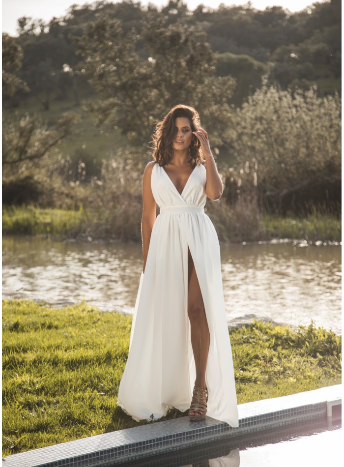 Long white dress with slit and plunging neckline