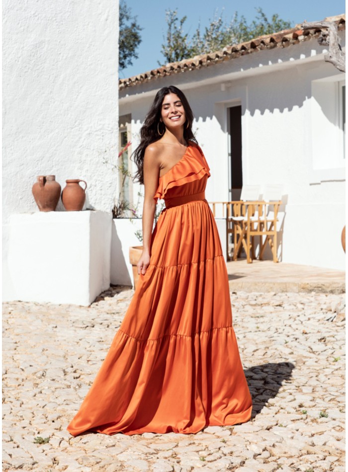 Long orange dress with ruffles and asymmetrical neckline