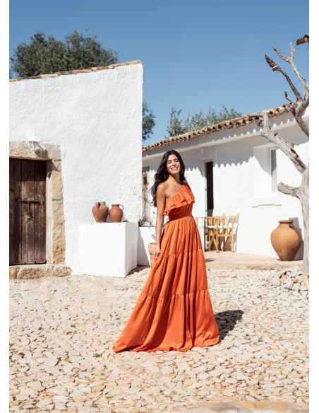Long orange dress with ruffles and asymmetrical neckline