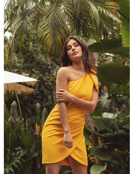 Short yellow dress with asymmetrical neckline and bow detail
