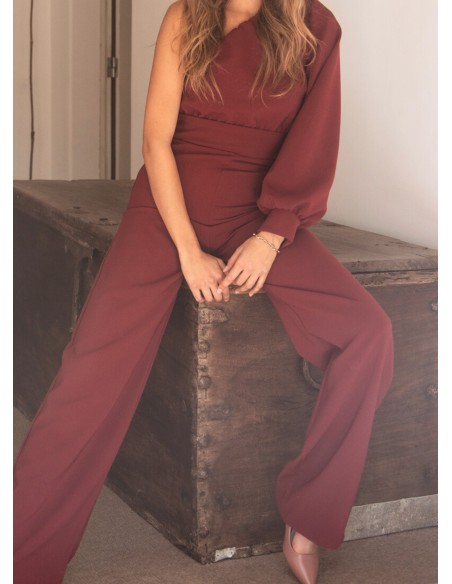 Long burgundy jumpsuit with asymmetrical neckline and long sleeves
