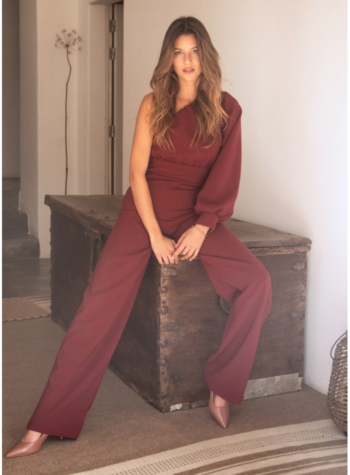 Long burgundy jumpsuit with asymmetrical neckline and long sleeves