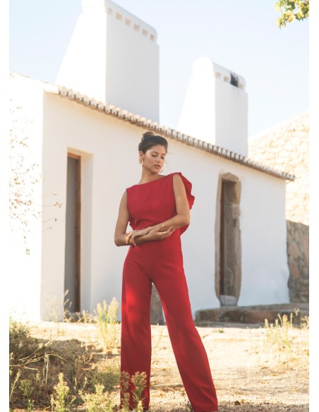 Long red jumpsuit with closed neckline and ruffle at the back