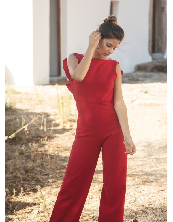 Long red jumpsuit with closed neckline and ruffle at the...