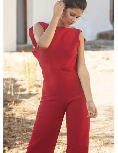 Long red jumpsuit with closed neckline and ruffle at the back