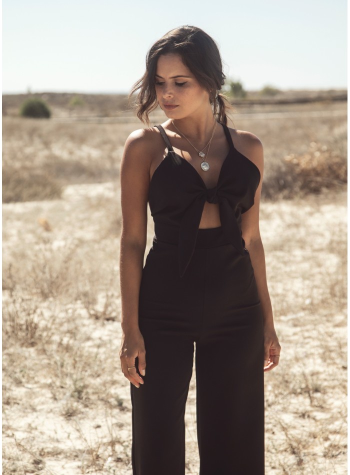 Black party jumpsuit knotted with suspenders