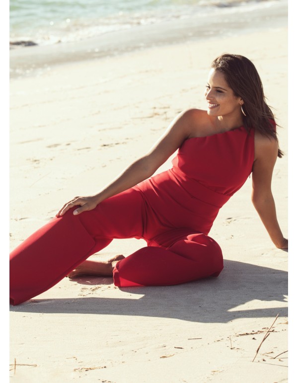 Asymmetrical red jumpsuit with lacing at the shoulder