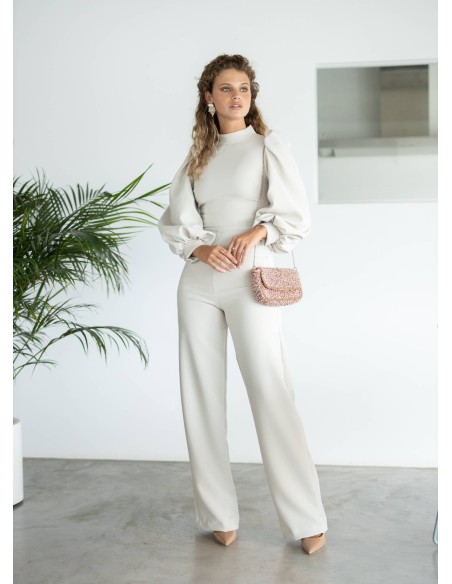 Beige jumpsuit with high collar and long puffed sleeves