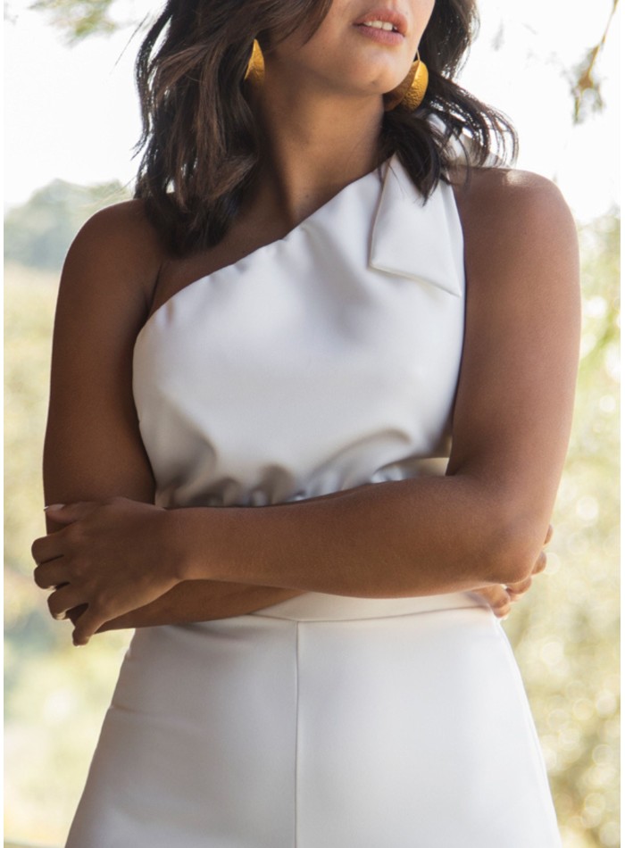 Long white jumpsuit with asymmetrical neckline...