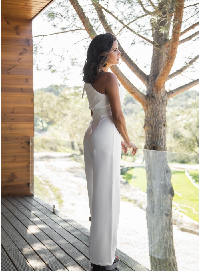 Long white jumpsuit with asymmetrical neckline...
