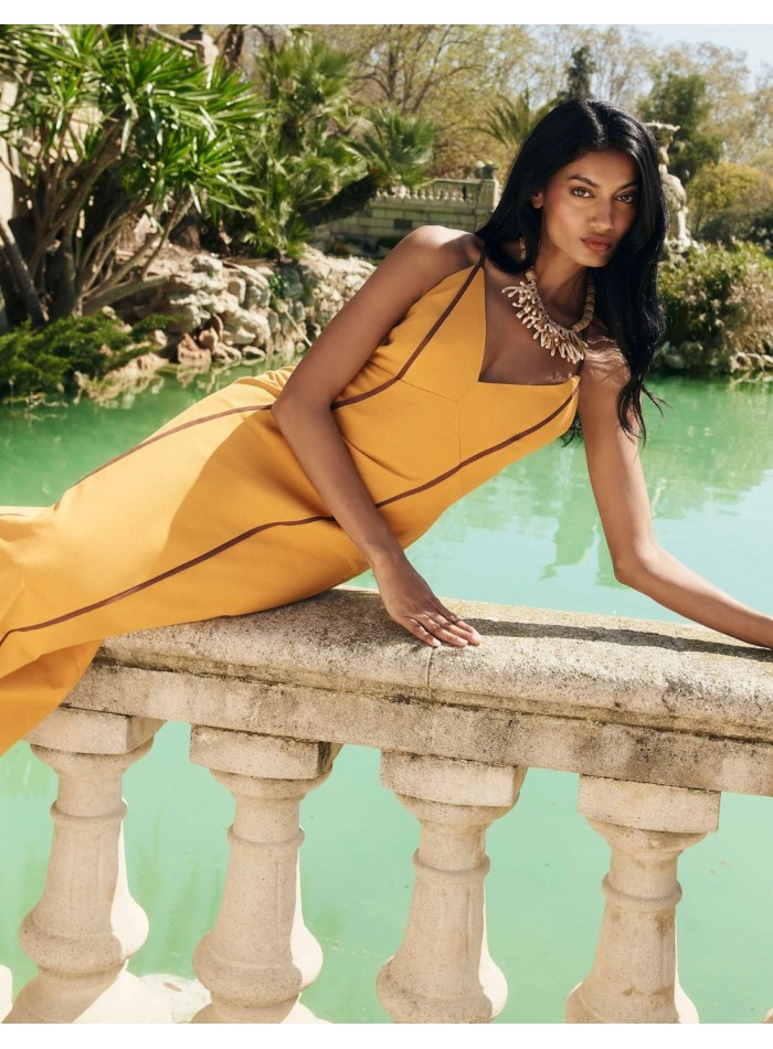 Vestido de invitada largo mostaza con caída fluida y detalles marrones