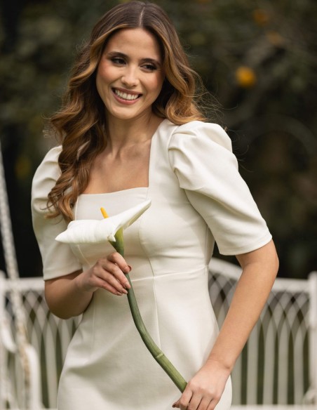 White midi dress with ruffled sleeves and bow detail