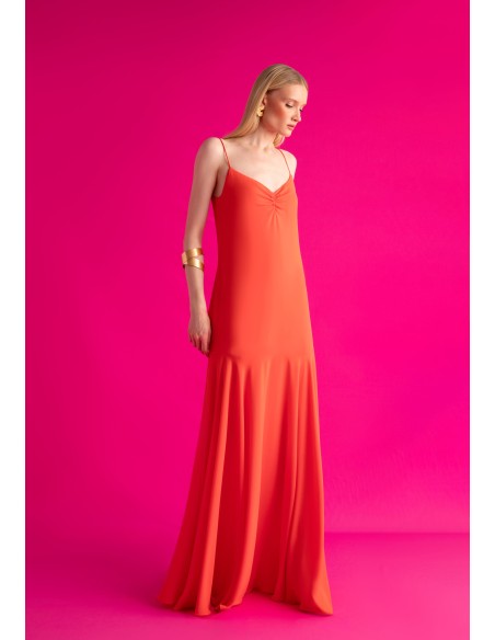 Long orange dress with ruffled neckline and cape skirt
