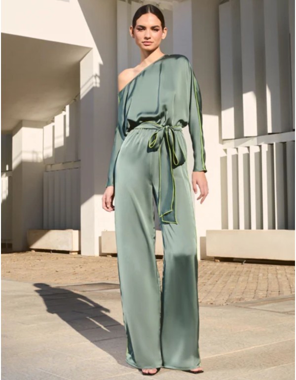 Asymmetrical satin green jumpsuit with bat sleeves and belt