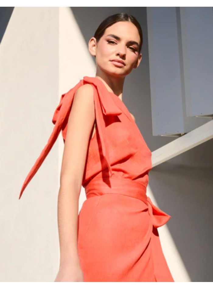 Orange asymmetrical top with lacing on the shoulder