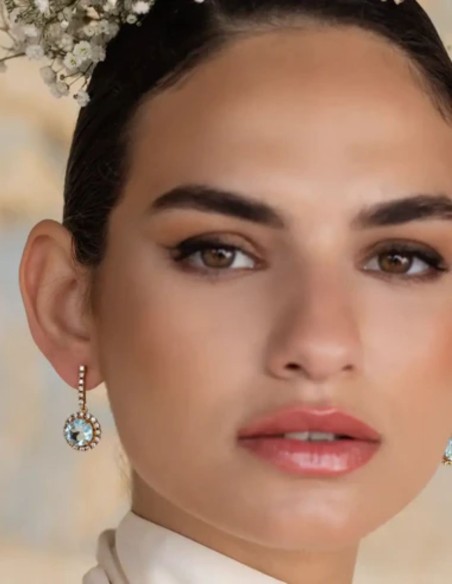 Earrings with aquamarine stone surrounded by zircons