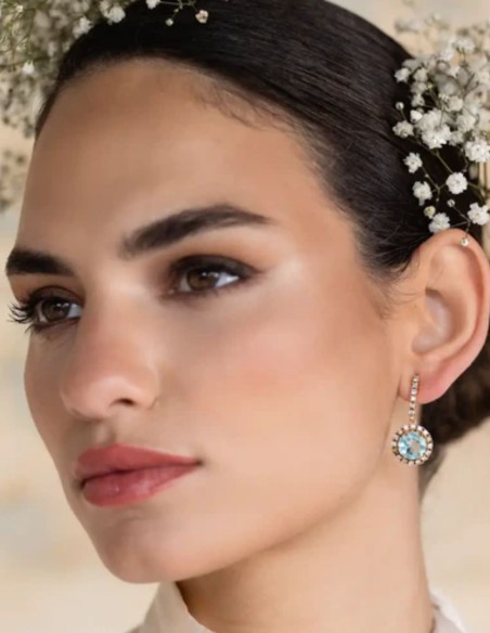 Earrings with faceted central stone surrounded by zircons