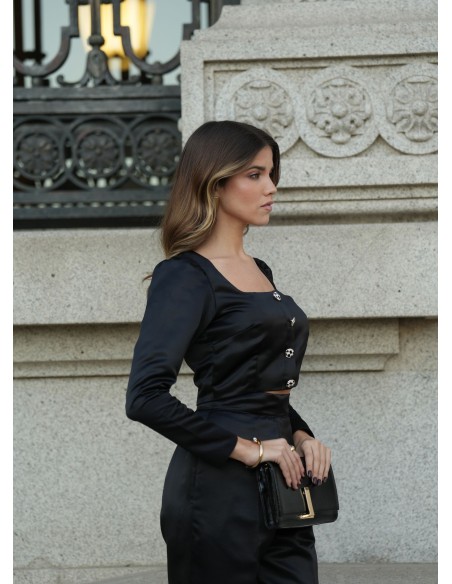 Black structured blouse with square neckline and long sleeves