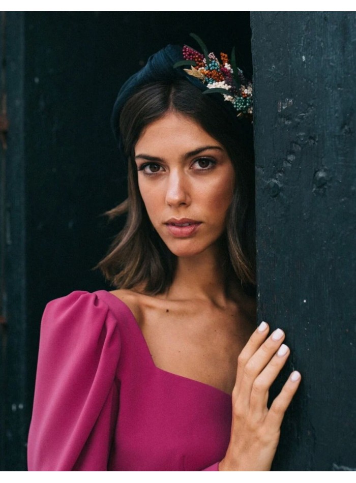 Navy blue headband with floral ornament on the...