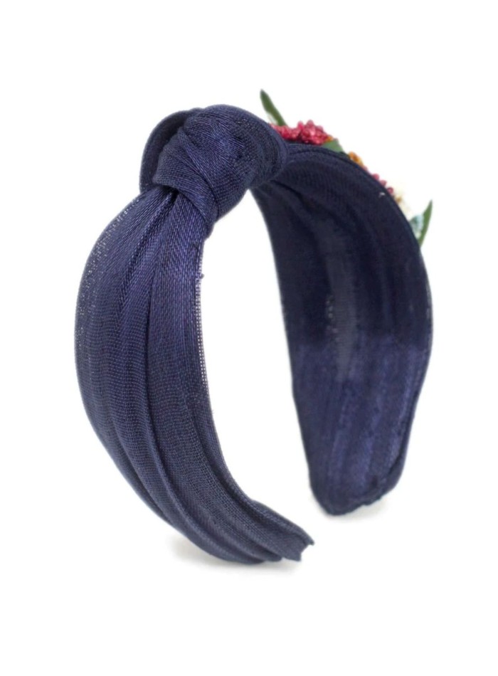 Navy blue headband with floral ornament on the...