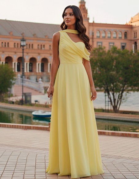 Pastel yellow long gown with asymmetrical neckline and cape sleeves
