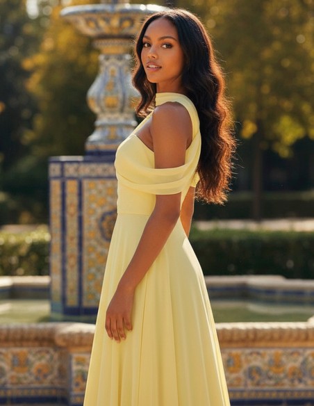 Pastel yellow long gown with asymmetrical neckline and cape sleeves