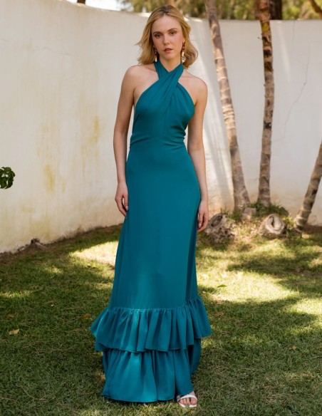 Green long guest dress with crossed halter neckline and ruffles on the skirt