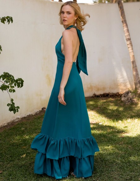 Green long guest dress with crossed halter neckline and ruffles on the skirt