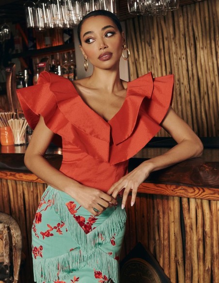Red taffeta top with ruffles at the neckline for guests