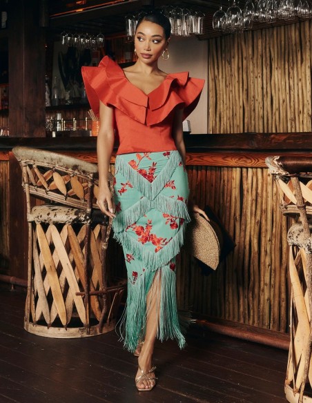 Red taffeta top with ruffles at the neckline for guests