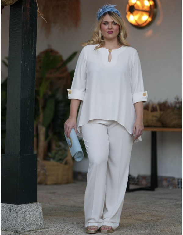 Ecru two-piece ensemble with rhinestone detail on cuffs...