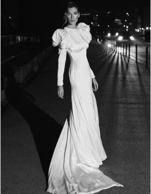 Wedding dress with puffed sleeves and draping at the...