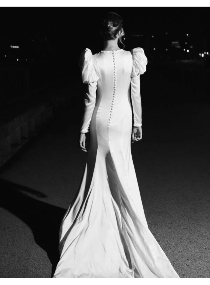 Wedding dress with puffed sleeves and draping...