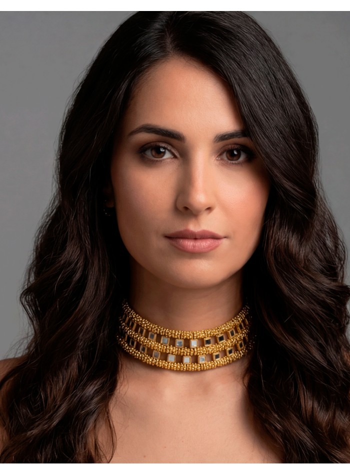 Choker rígido de diseño fino con delicados espejitos, una pieza sofisticada que aporta luz y elegancia de forma sutil.