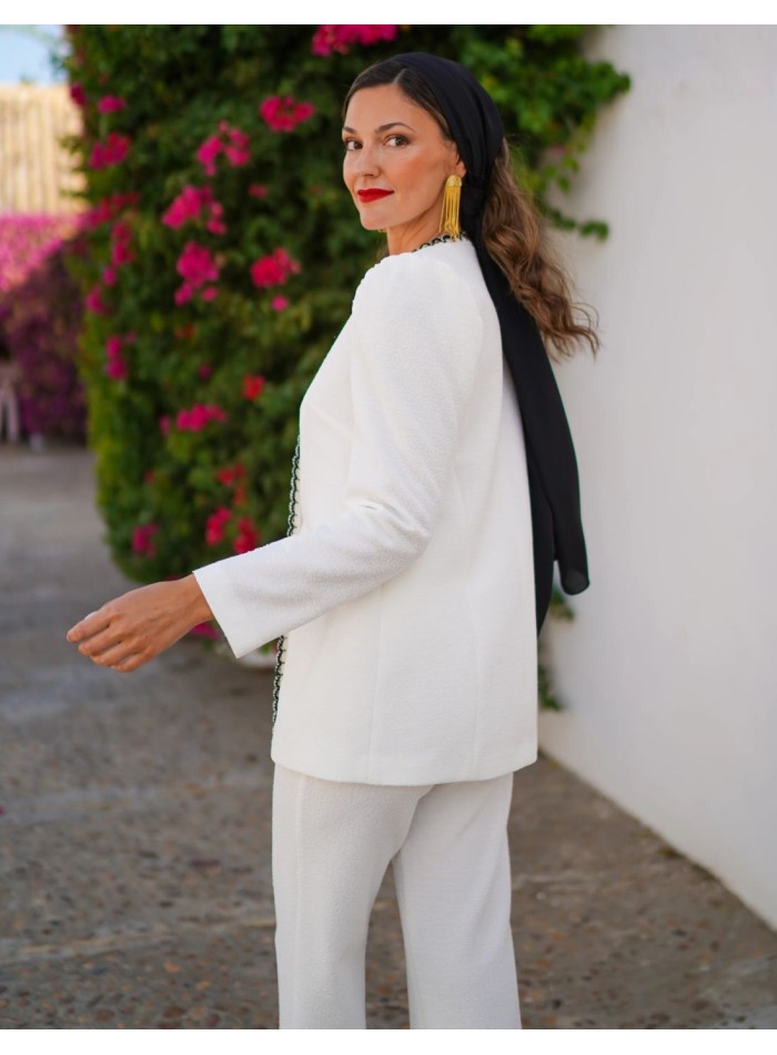 Two-piece suit with black embroidery detail and...