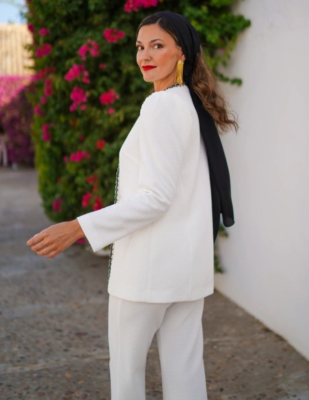 Two-piece suit with black embroidery detail and gold buttons