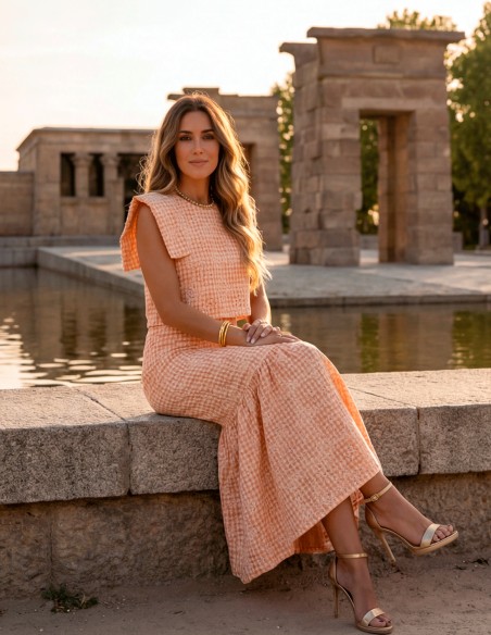 Orange two-piece guest ensemble with midi skirt and structured top