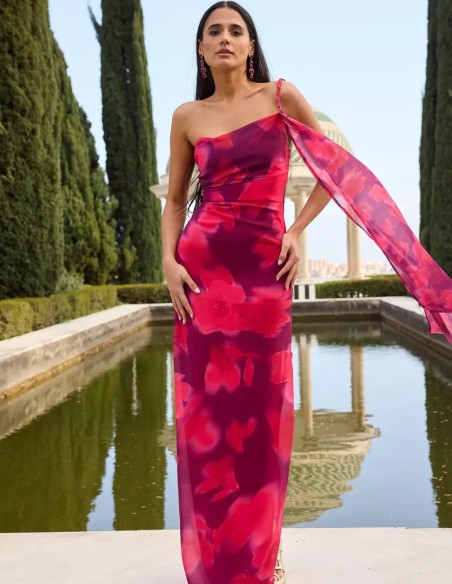 Long dress with asymmetrical neckline and fabric with floral motifs in purple tones