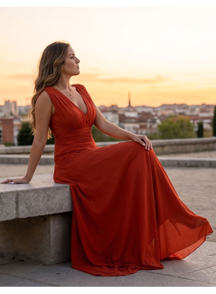 Long russet color dress with V-neck and draped...