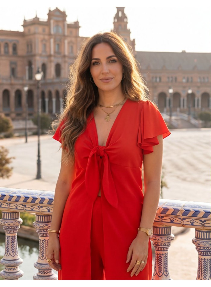 Red guest ensemble of blouse with knot detail...