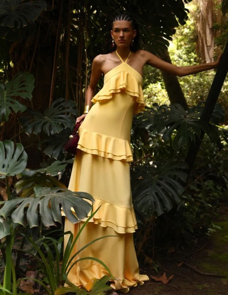 Long pastel yellow dress with halter neckline and ruffles