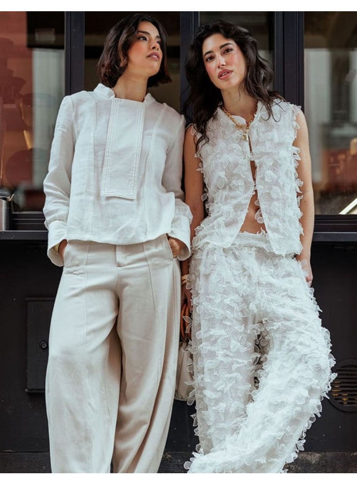 Off-white flowing pants with floral embossing