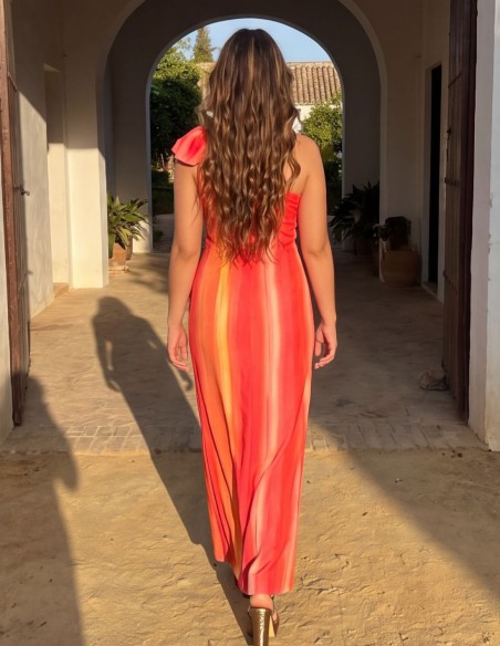 Guest dress in shades of pink and orange with an asymmetrical neckline